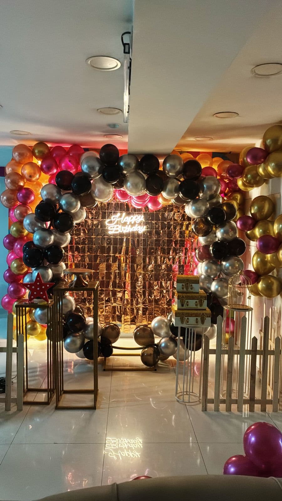 Happy Birthday neon sign with gold sequin wall and balloon arch